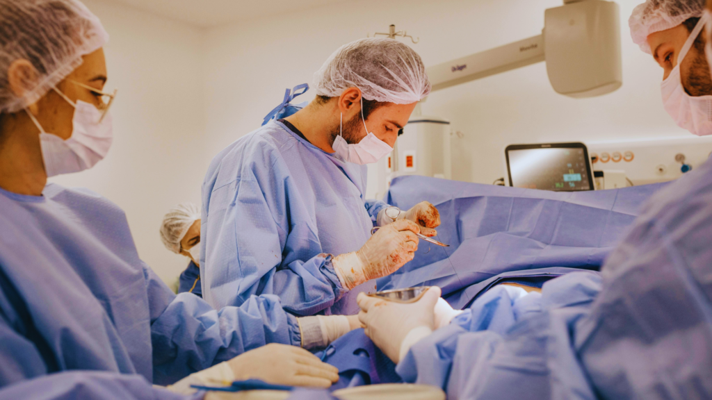 Surgeon performing endourology with laser and endoscope tools.