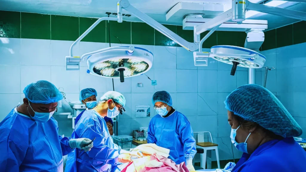 Surgical team performing laser kidney stone surgery